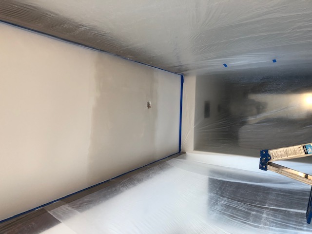 Water damage ceiling restored before removing containment barriers